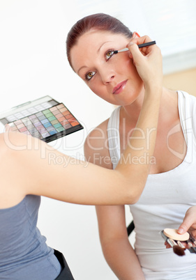 woman making-up her female friend