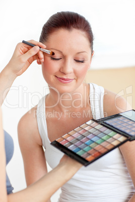 woman having a make-up lesson at home