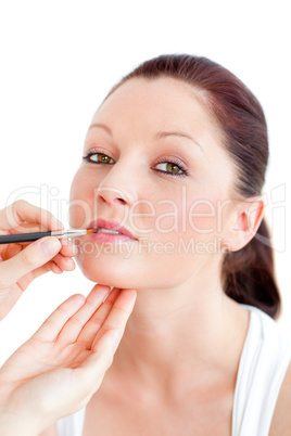 woman being made-up by a professional artist