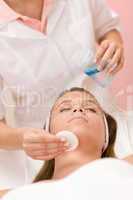 Skin care - woman cleaning face