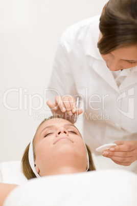 Using tweezers - woman having facial