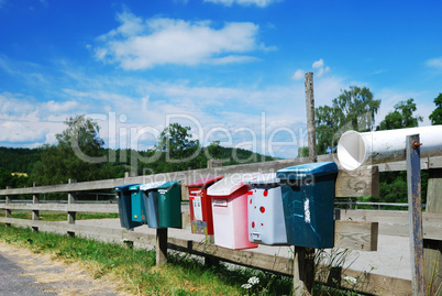 Country mailboxes on the fence
