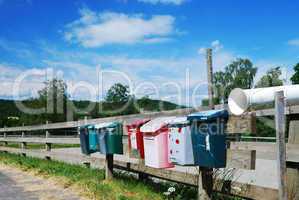 Country mailboxes on the fence