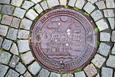 Sewer manhole on stone pavement of Trondheim.