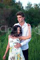 young man with girl look at sunset