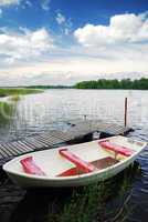 Swedish lake with small wooden wharf and boat