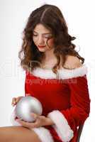 Pensive teenage girl with christmas ball