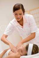 Skincare - woman cleavage massage at salon