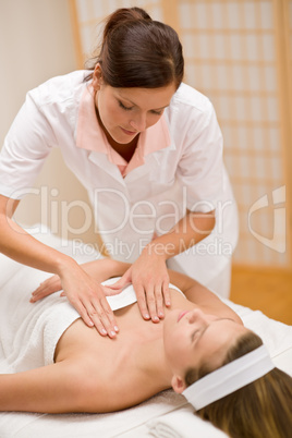Skincare - woman cleavage massage at salon