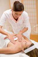 Skincare - woman cleavage massage at salon