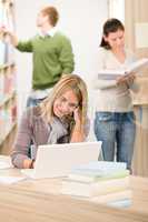 High school library - thoughtful student with laptop