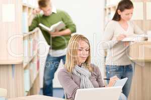 High school library - thoughtful student with laptop