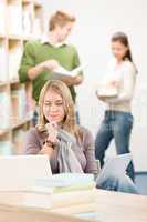 High school library - thoughtful student with laptop