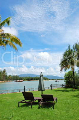 Sunbeds at lawn of luxury villa, Phuket, Thailand