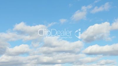 Motion background - white clouds flying on blue sky