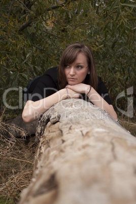 Young women posing on a log