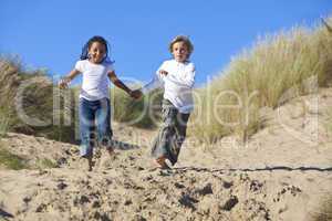 Blond Boy & Mixed Race Girl Running At Beach