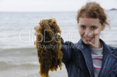Young woman holding seaweed