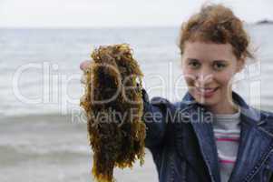 Young woman holding seaweed