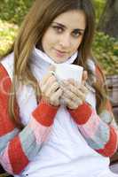 Girl holding coffee cup and smiling