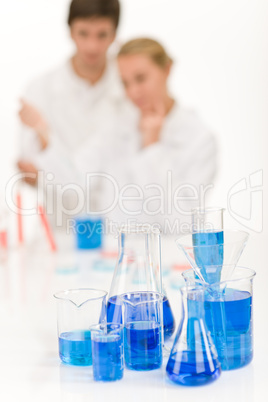 Scientists in laboratory - blue liquid