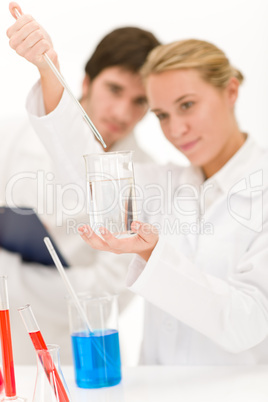 Scientists in laboratory with chemicals
