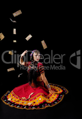 woman in traditional indian costume againist falling money