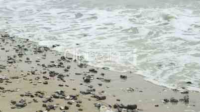 waves break on shingle beach