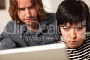 Young Man and Diligent Woman Using Laptop Together