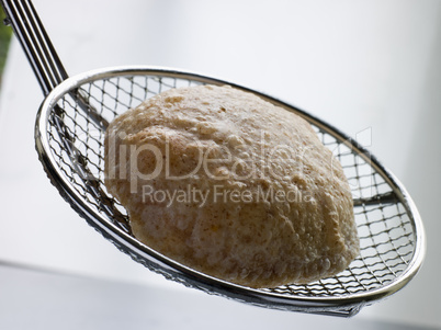 Deep Fried Puff Bread on a Strainer