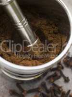 Ground Clove Powder in a Pestle and Mortar