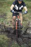 Mountain biker crossing mud