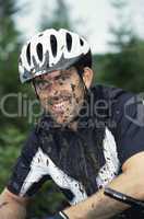 Mountain biker covered in mud