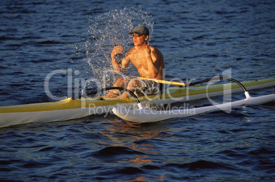 Man refreshing while canoeing