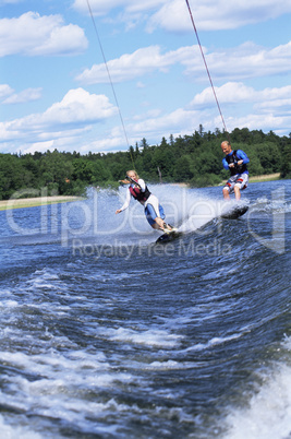 A man and woman water-skiing
