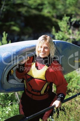 Young woman carrying kayak