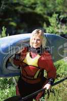 Young woman carrying kayak