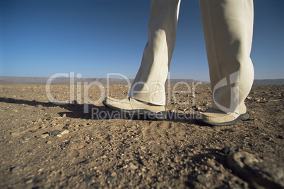 Man walking in desert, low section, ,