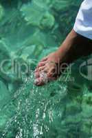Young woman dipping toes in water