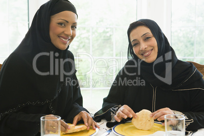 Two Middle Eastern women enjoying a meal