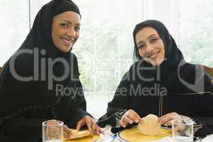 Two Middle Eastern women enjoying a meal