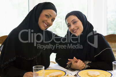 Two Middle Eastern women enjoying a meal