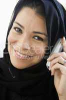 A middle eastern woman talking on a cellphone