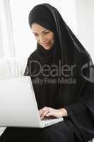 A middle eastern woman using a laptop