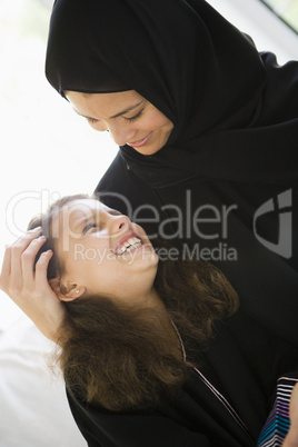 A Middle Eastern woman with her daughter