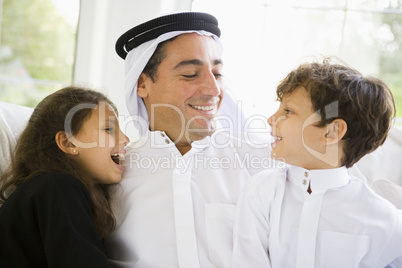 A Middle Eastern man with his children