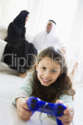 A Middle Eastern girl playing a video game