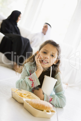 A Middle Eastern girl enjoying a fast food burger meal