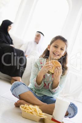 A Middle Eastern girl enjoying a fast food burger meal