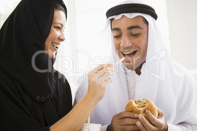 A Middle Eastern couple sharing a fast food meal